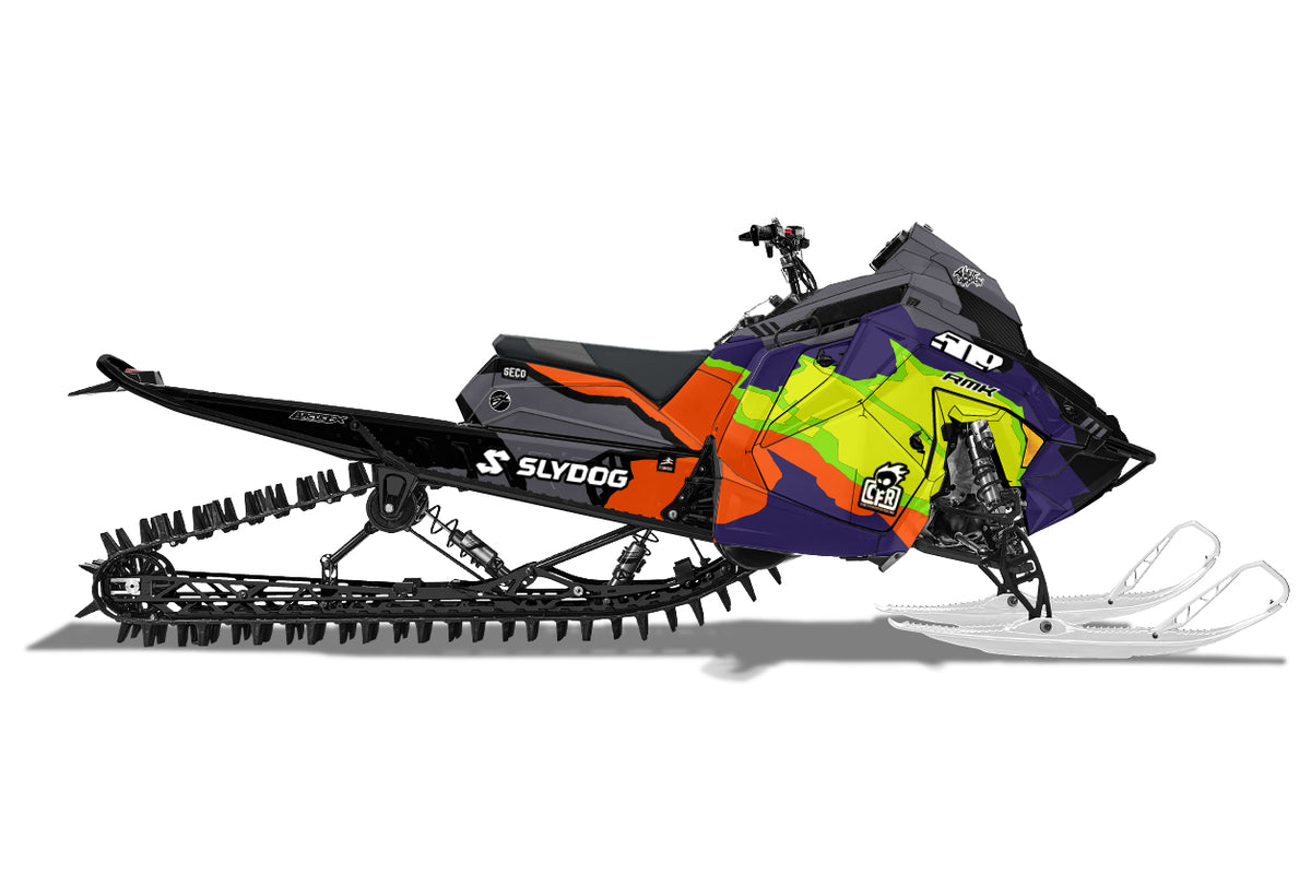 A side profile view of a Polaris snowmobile with a vibrant custom graphic wrap. The wrap features a bold pattern of neon yellow, lime green, purple, and orange on a black base, with white Slydog branding on the tunnel.
